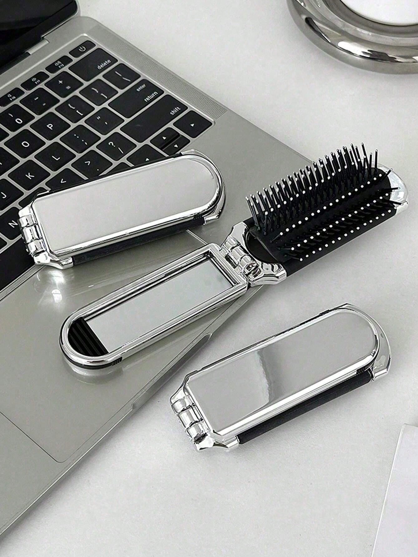 A Shiny Electroplated Silver Comb With A Foldable Design, A Small Mirror, Compact And Portable