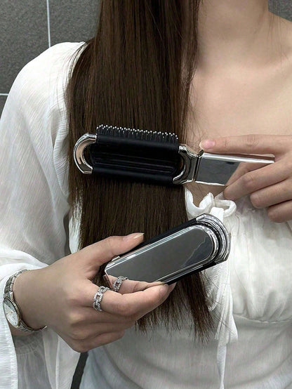 A Shiny Electroplated Silver Comb With A Foldable Design, A Small Mirror, Compact And Portable
