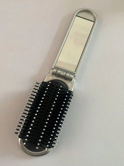 A Shiny Electroplated Silver Comb With A Foldable Design, A Small Mirror, Compact And Portable