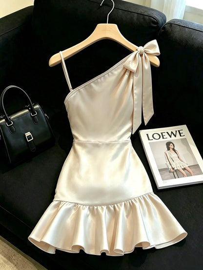 Franclia Champagne Satin Dress With Soft Luminous Texture, Asymmetrical Shoulder Bow Design, Delicate Side Straps, Ruched Waist For Flattering Silhouette, Ruffle Hem, Fitted Cut, Elegant And Sli